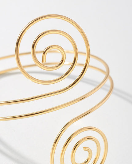 Lightweight gold spiral arm bracelet with sculptural goddess style

