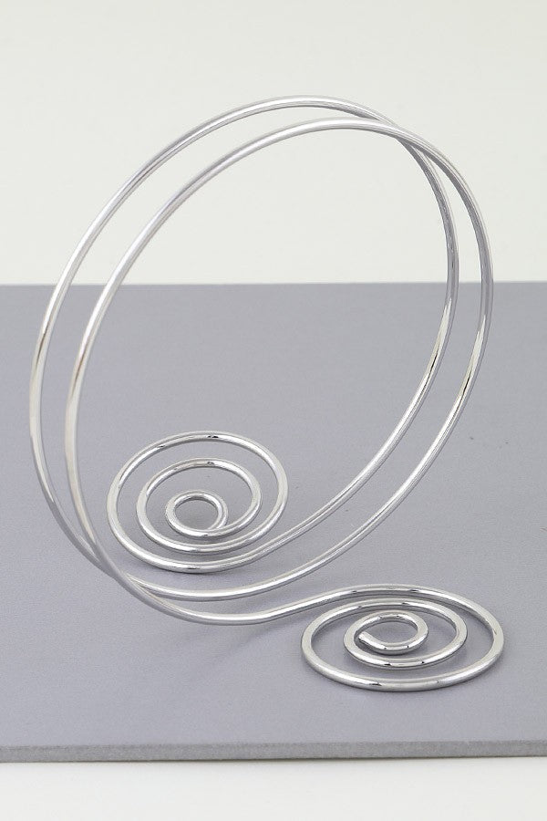 Silver spiral arm cuff with twin swirl shape and open wire wrap

