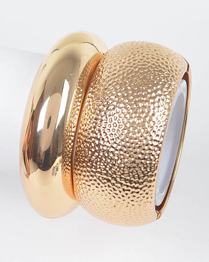 Chunky hammered gold bracelet with metallic shine and bold structure

