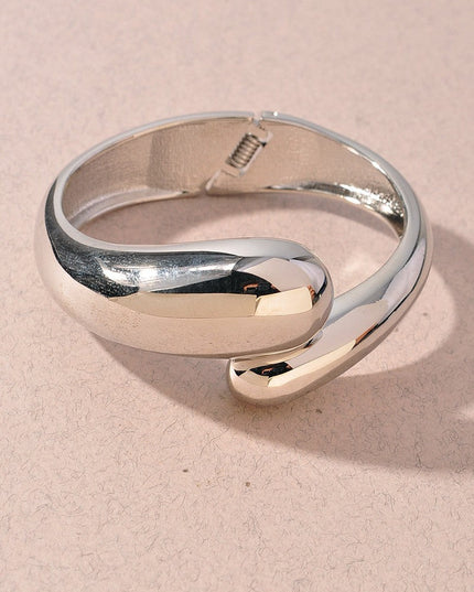 Silver curved cuff bracelet with abstract sculptural silhouette

