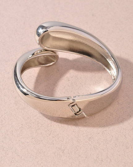 Glossy silver metal bangle with high-polish minimalist design


