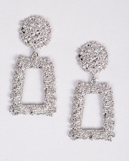 Sculptural silver earrings with hammered finish and geometric drop

