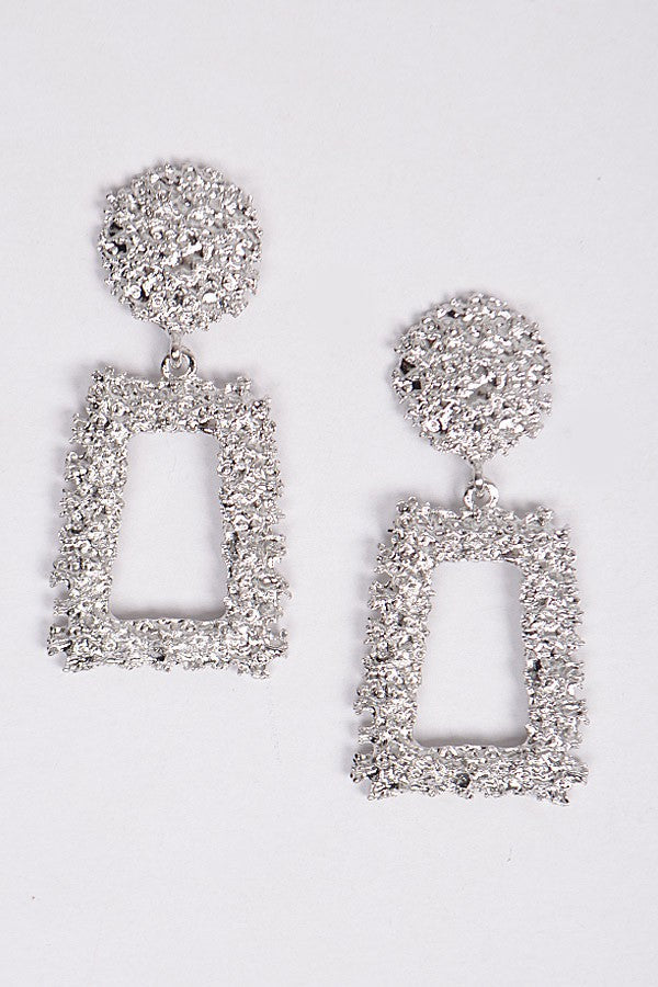 Sculptural silver earrings with hammered finish and geometric drop

