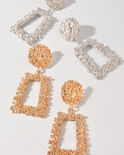 Shiny silver statement earrings in textured alloy with cut-out shape

