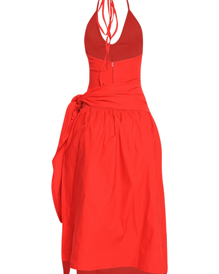 Red vacation-ready midi with wrap skirt, halter straps, and bold feminine energy