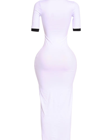 Back angle of white polo-inspired maxi with black collar and cuffs, minimalist athletic vibe

