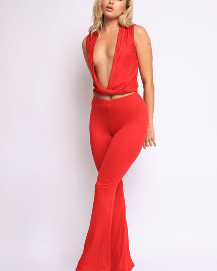 Bold red deep V neckline two-piece set with twisted crop top and flared pants

