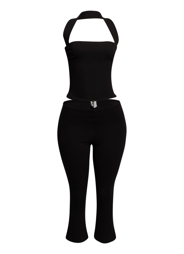 Sleek black halter top and fitted capri pant set, perfect for edgy, on-trend party looks.