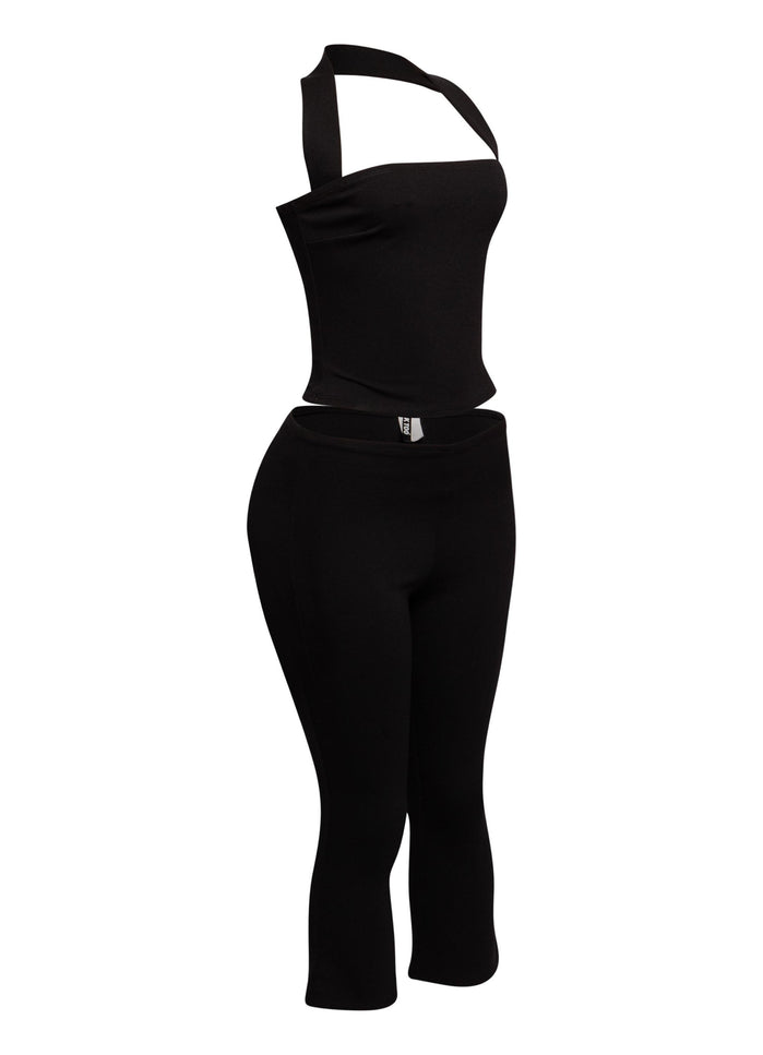 Chic halter neck top paired with figure-hugging capri pants, ideal for a bold and sophisticated outfit.