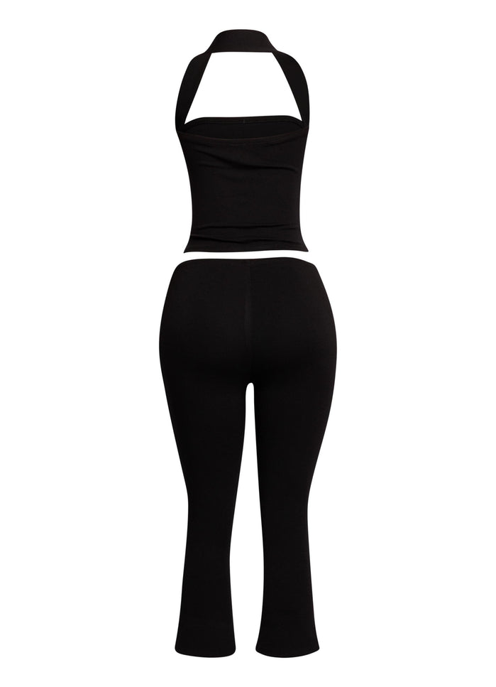 Minimalist yet striking black two-piece set featuring a halter top and cropped capri pants, perfect for nights out.