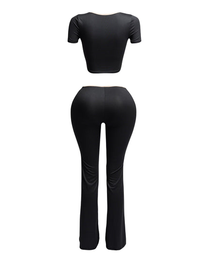 Back view of black two-piece set with nude trim, showing fitted crop top and curve-hugging flared pants.