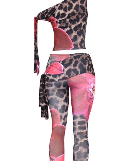Asymmetrical pink two-piece with sleeveless crop top and vibrant capri bottoms

