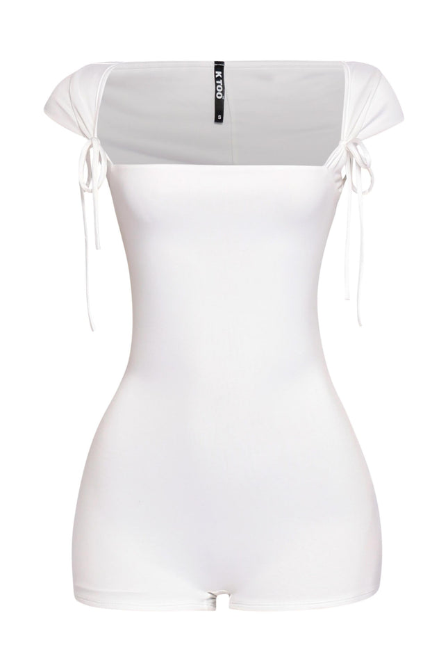 White cap sleeve romper with wide neckline and dainty shoulder tie details in bodycon fit

