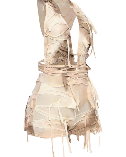 Apocalyptic ivory sleeveless romper with open back and layered fraying

