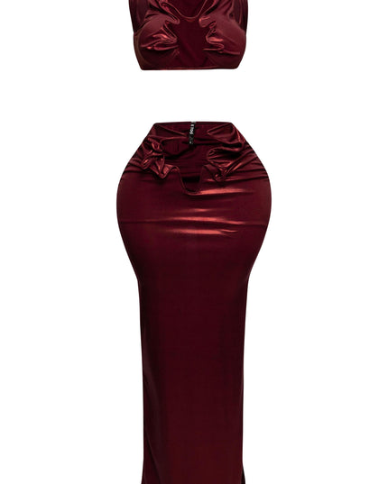 Front shot of shiny foiled tank top with cutout details paired with a high-waisted maxi skirt."