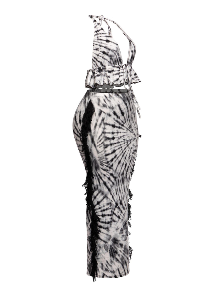 Monochrome tie-dye festival outfit with dramatic fringe and bold ruffle details


