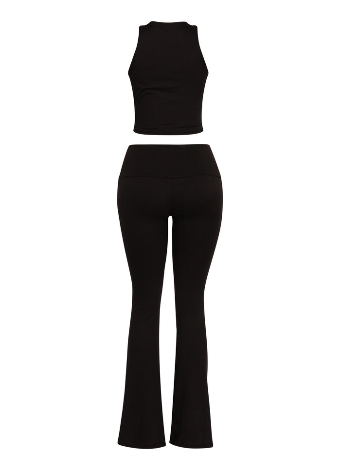 Black matching set featuring Y2K-inspired twist front top and sleek high-waisted pants

