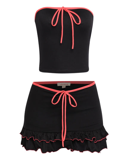 Black contrast trim mini skirt set with hot pink piping, tie-front tube top, and flared ruffle hem