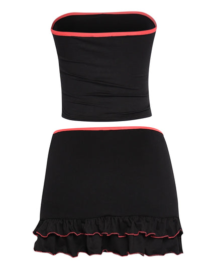 Black bodycon two-piece with neon pink edges, stretchy tube top, and midrise skirt with playful hemline