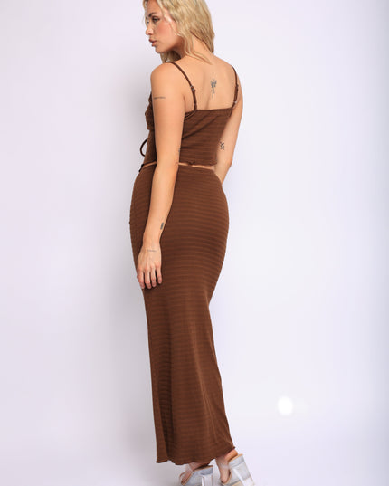 Chocolate brown two-piece outfit with ruched bustier and long curve-hugging skirt

