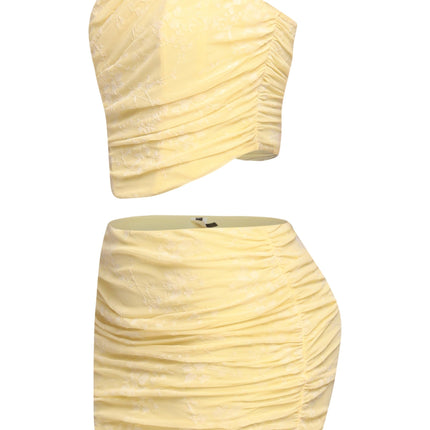 Back zipper detail on yellow bandeau top with ruched mini skirt

