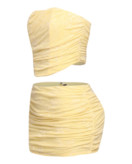 Back zipper detail on yellow bandeau top with ruched mini skirt

