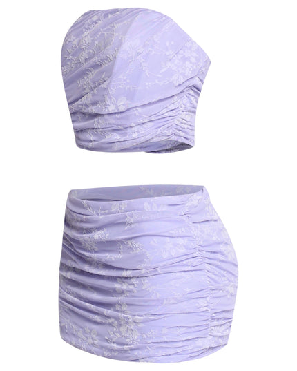 Back view of lavender crop top with exposed zipper and matching skirt

